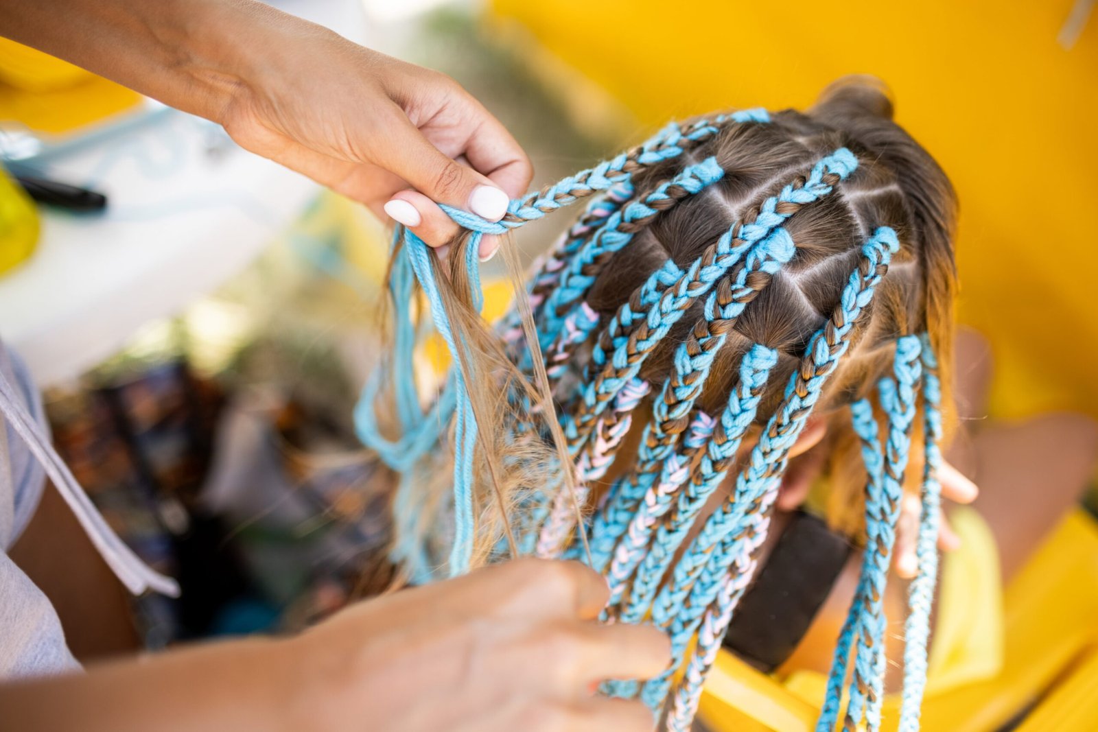 a-girl-in-a-suit-weaves-african-braids-in-her-hair-2025-01-29-04-53-33-utc-min